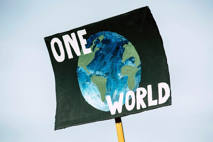 One World poster, globe with black background.