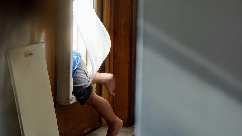 child crawling out of window child crawling out of window
