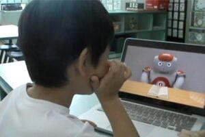 Child viewing a screen with a robot on it