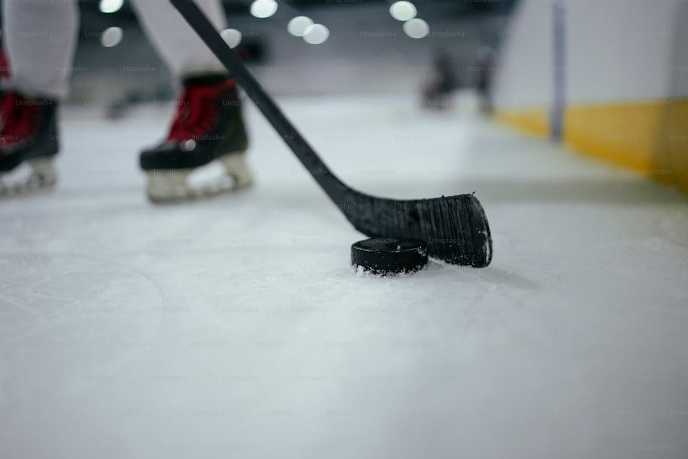 a close up of a hockey stick and a hockey puck