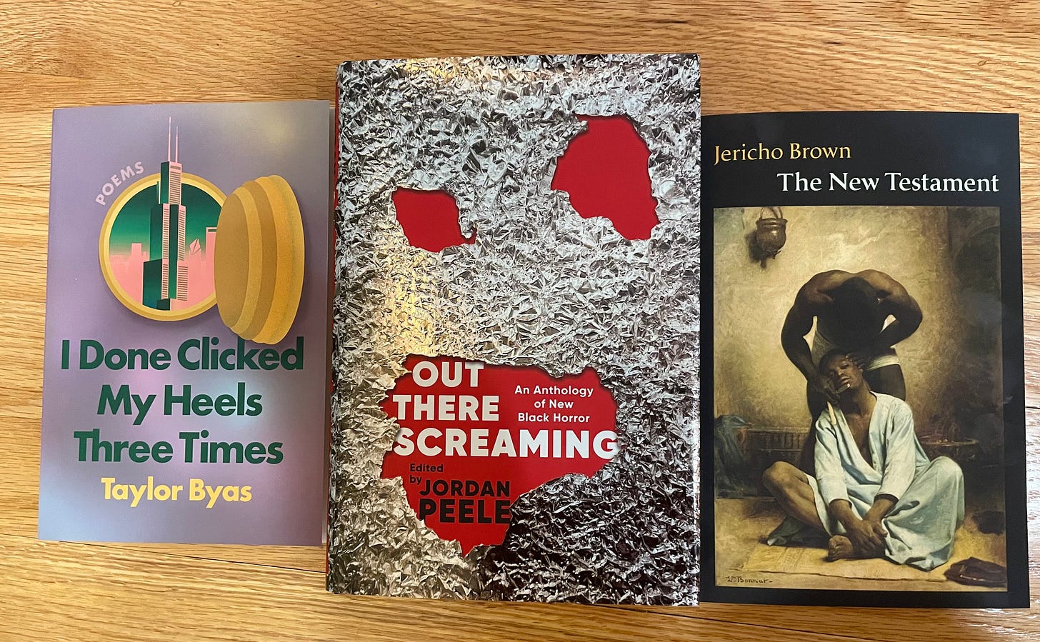books: I Done Clicked My Heels Three Times by Taylor Byas, Out There Screaming edited by Jordan Peele, and The New Testament by Jericho Brown