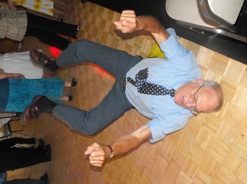 70-year-old grandfather is on his back on the dancefloor during the song "Shout"