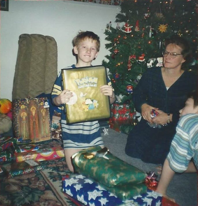 Ethan holding up his new Pokémon TCG binder on Christmas 2002, excited to collect Neo cards