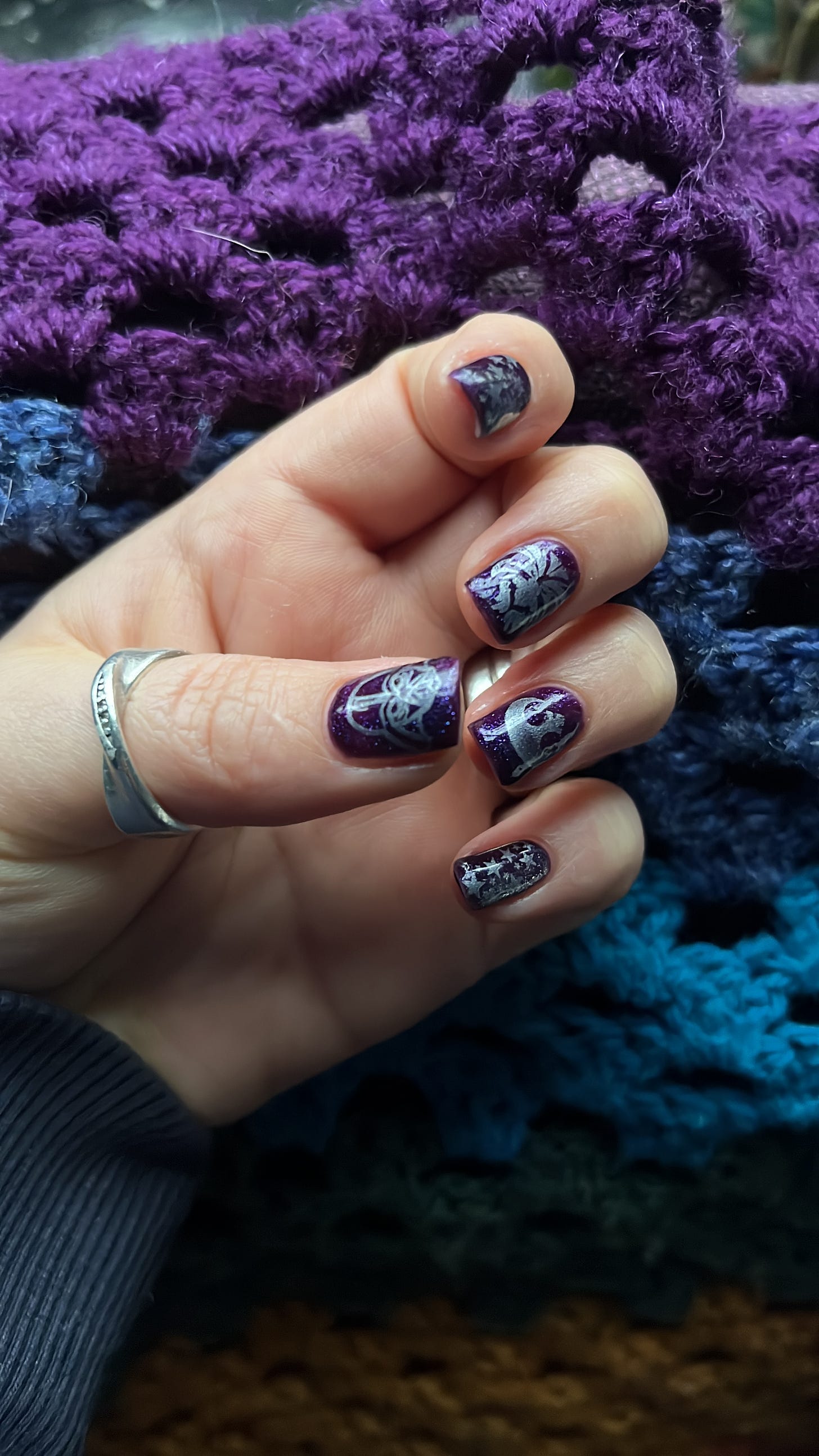 A picture of purple nails with star wars motifs
