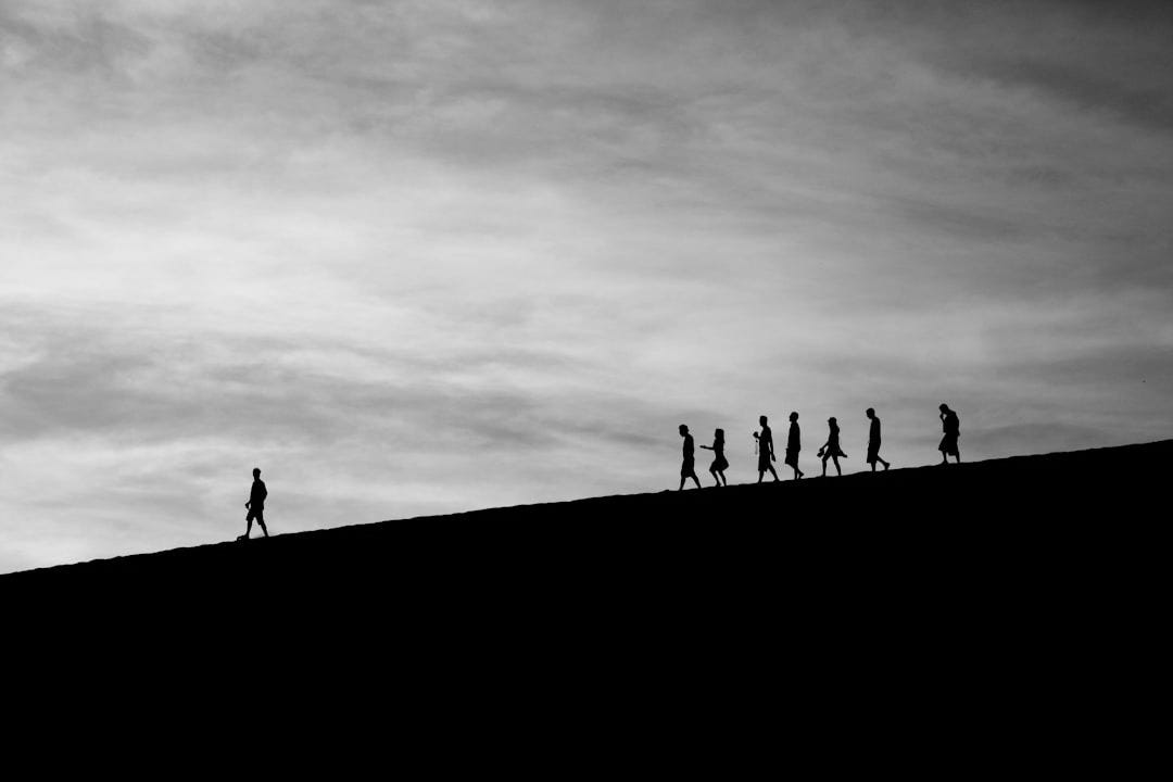 silhouette of people on hill silhouette of people on hill