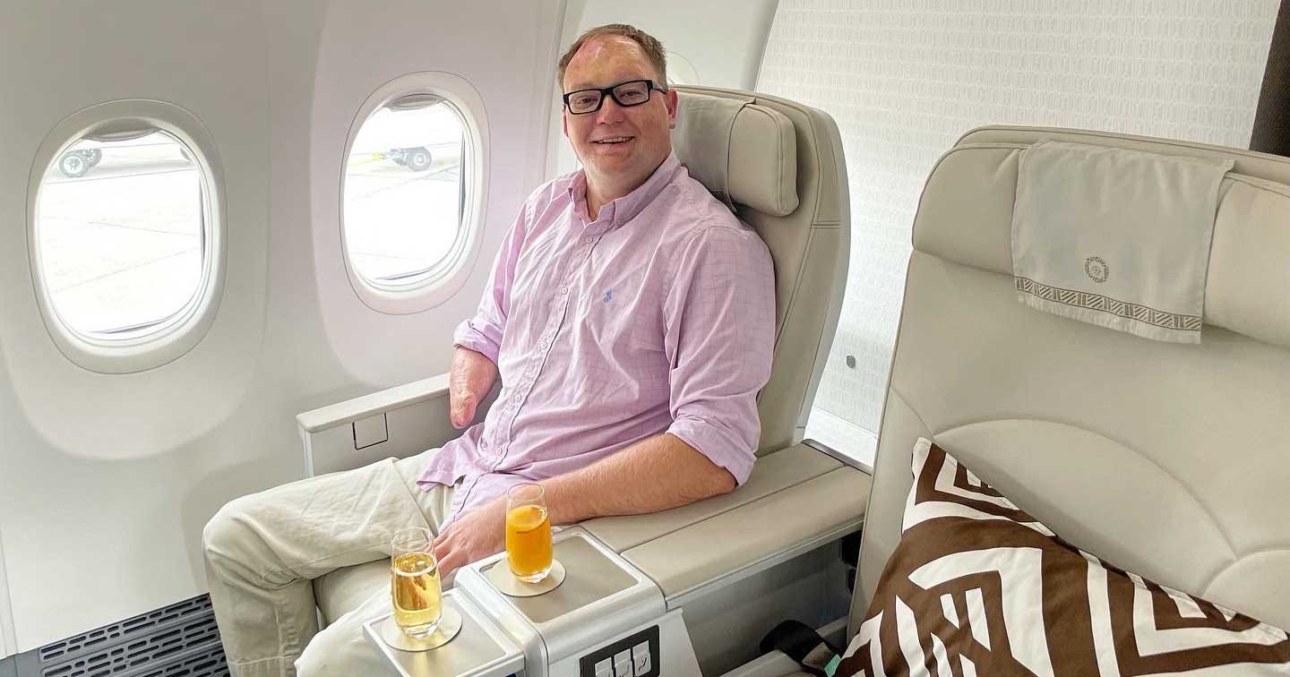 John seated in a business class cabin on Fiji Airways.