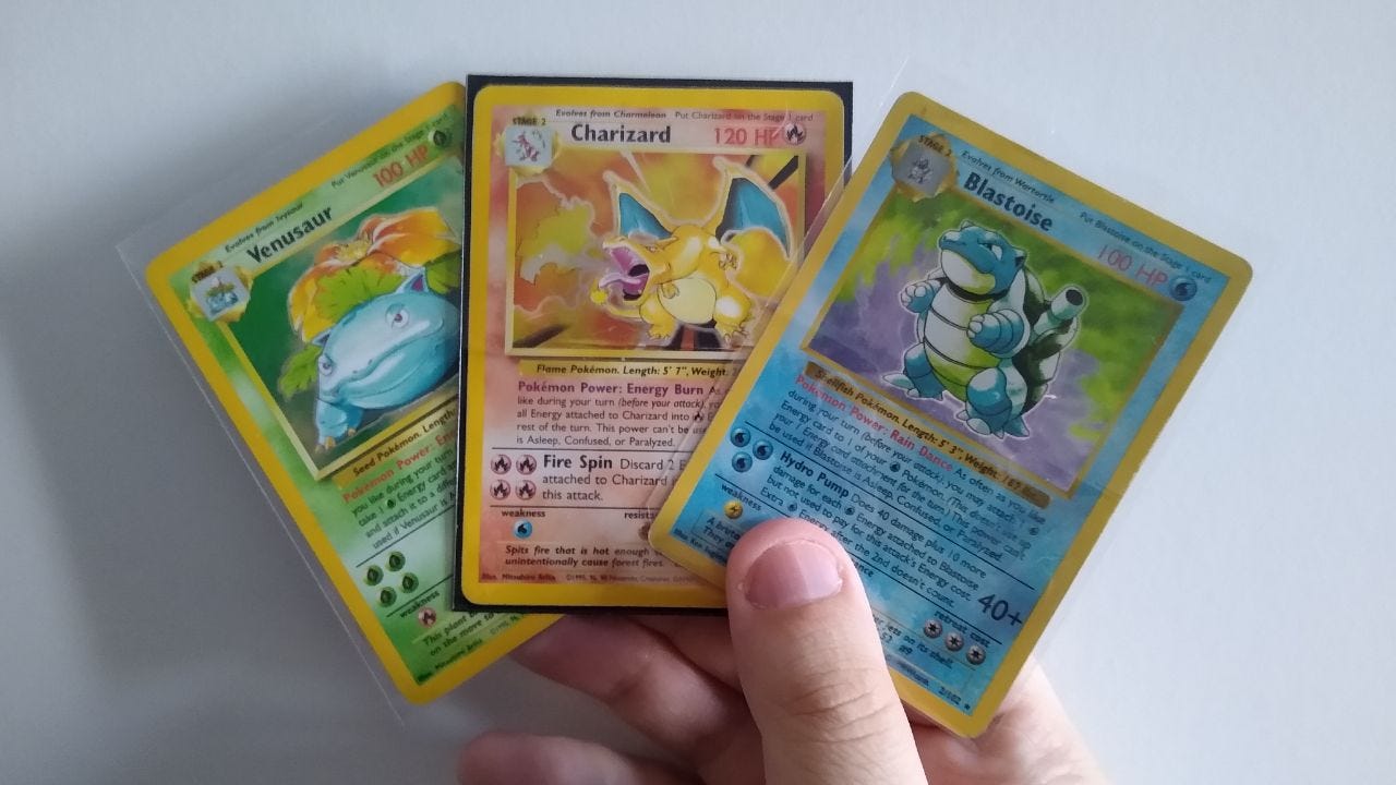 A photograph of Venusaur, Charizard and Blastoise base set trading cards