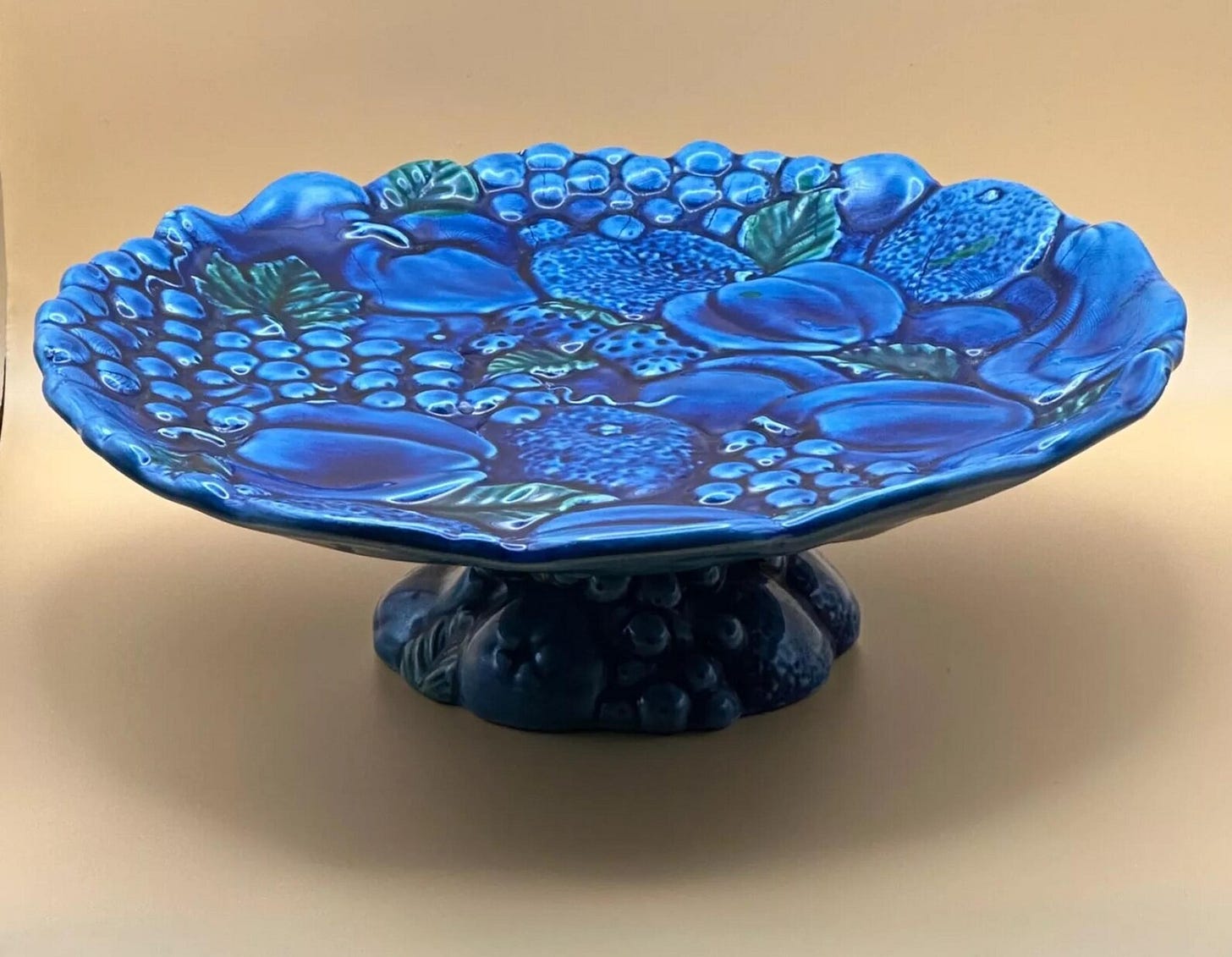 Blue cake plate pottery with fruit.