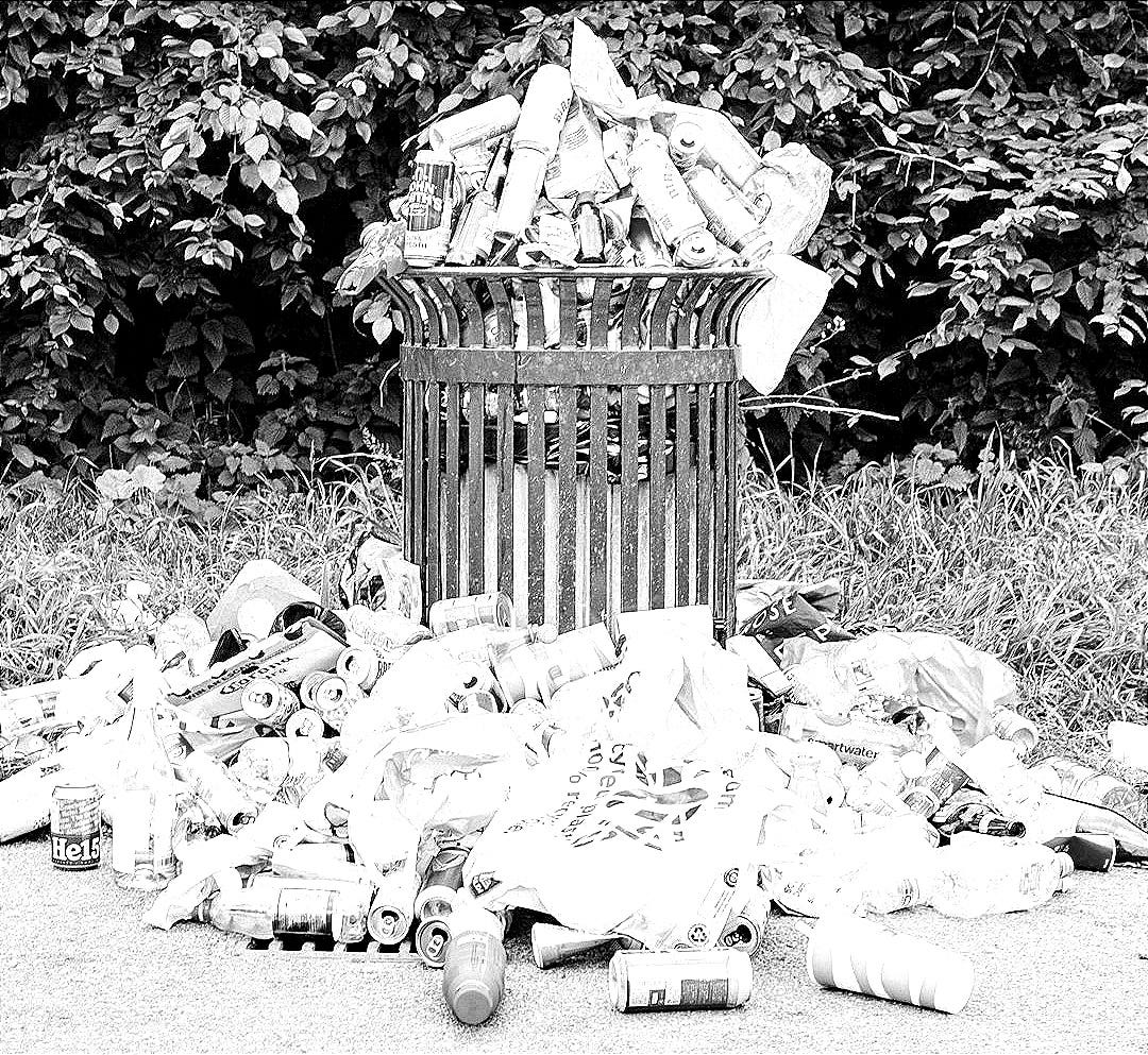 a trash can filled with plastic bottles and other trash