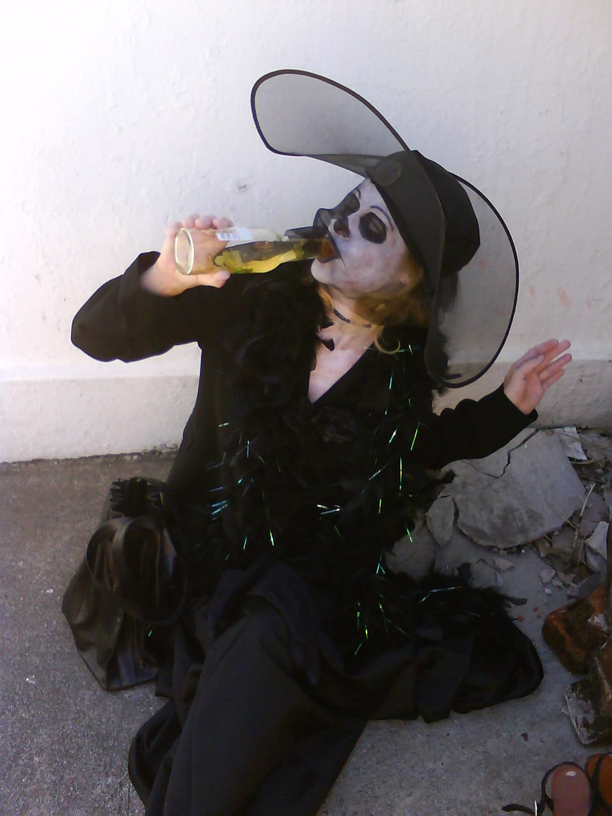 woman painted as Katrina Day of the Dead drinking Coors Light in a graveyard in New Orleans