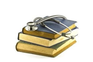 3 old books with a stethoscope on top of them
