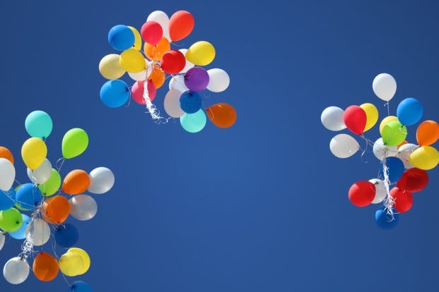 A group of balloons in the sky

Description automatically generated