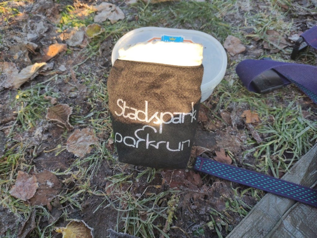 A black bag used to keep finish tokens. 'Stadspark parkrun' has been transferred on in silver.