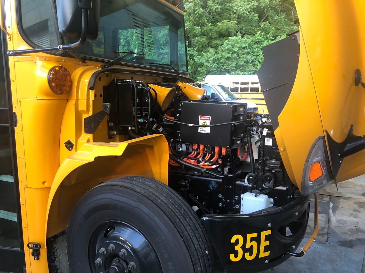 A Navistar IC electric bus owned by Putnam County Schools in Tennessee with hood opened to expose electric motor