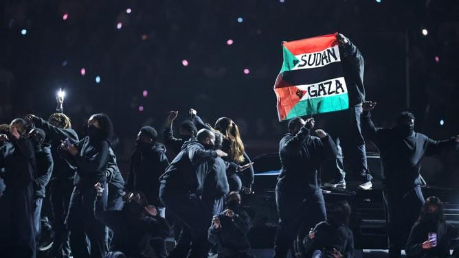 Super Bowl: Protester holds Sudanese, Palestinian flag above head during  Kendrick Lamar's performance | PerthNow