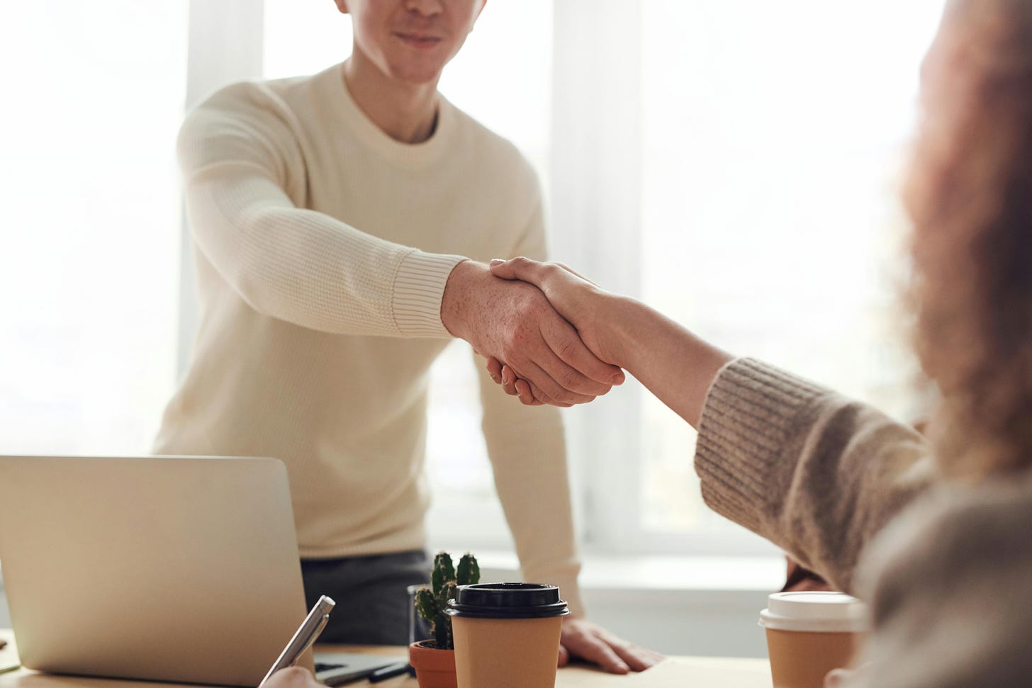 Two people shaking hands, one presumably a hiring manager