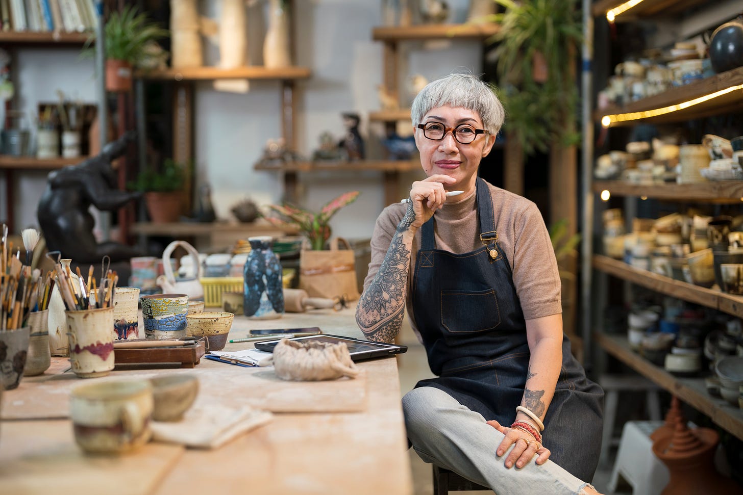 Portrait Female potter sitting in her studio