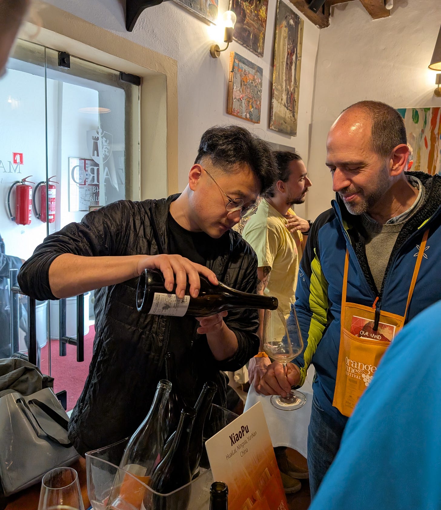 Ian Hongjing Dai pours wine at OWF Izola 2025. Photo (C) Simon J Woolf