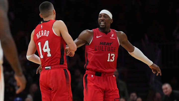 Dec 7, 2024; Miami, Florida, USA;  Miami Heat center Bam Adebayo (13) celebrates with guard Tyler Herro (14) after Herro made a three-point basket against the Phoenix Suns during the second half at Kaseya Center. Mandatory Credit: Jim Rassol-Imagn Images