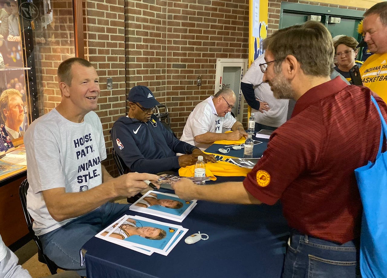 George McGinnis signs autographs at Pacers FanJam 2019 between Rik Smits and Billy Keller.