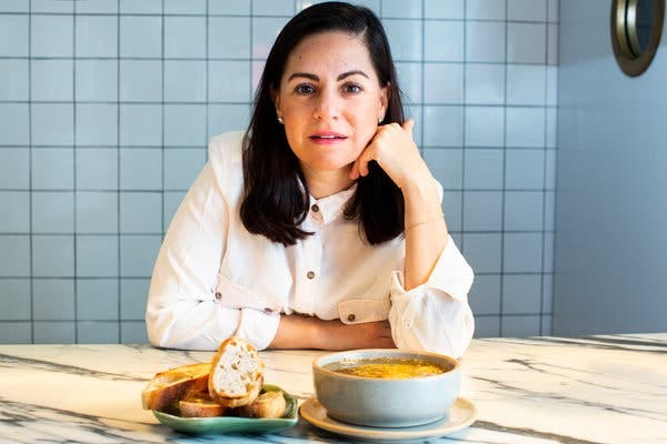 The chef Paulina Escanes with her popular queso artisanal al horno: bubbling hot fresh cheese, with olive oil, oregano, garlic and toasted local bread.