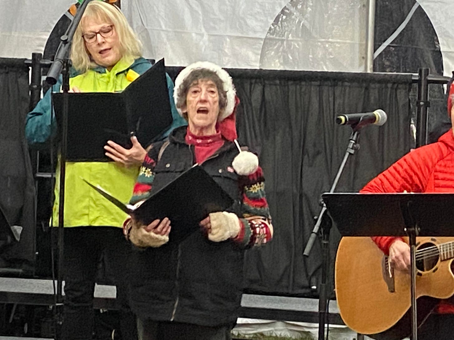 a picture of me singing with the choir at a tree lighting ceremony