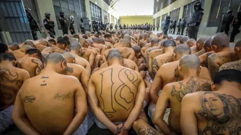 Reuters Gang members wait to be taken to their cells after 2000 gang members were transferred to the Terrorism Confinement Center
