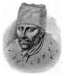 The bust of a man with a hat and an ermine cloak.