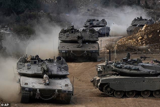 Israeli army tanks manoeuvre in a staging area in northern Israel near the Israel-Lebanon border, Tuesday, Oct. 1, 2024