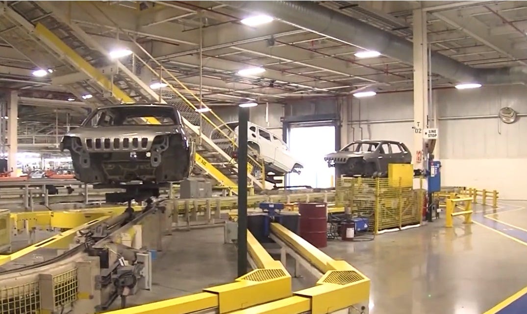 screenshot of partly-assembled Jeep SUVs on an assembly line