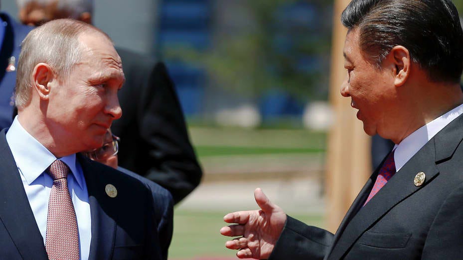 Chinese President Xi Jinping speaks with Russian President Vladimir Putin as leaders gather for a family photo during the Belt and Road Forum on Yanqi Lake, outside Beijing, China, May 15, 2017.