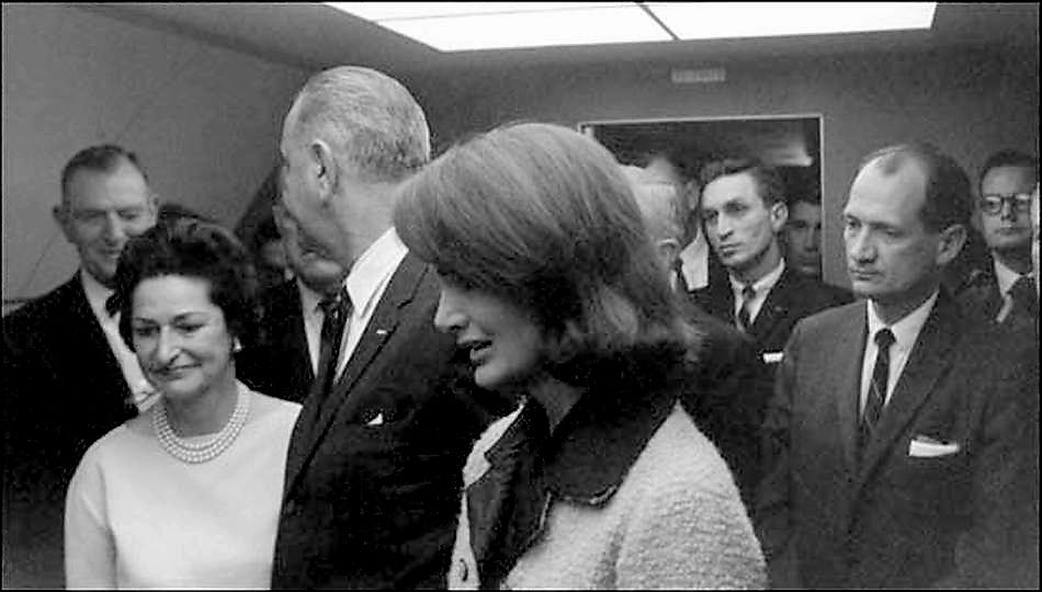 Photographs, taken by White House photographer Cecil Stoughton of Vice President Johnson taking the oath of office aboard Air Force One at Love Field, show President Johnson and Congressman Albert Thomas winking and smiling at each other immediately after the grim ceremony. The original negative to that photo is the only one missing from that series of 13 exposures.