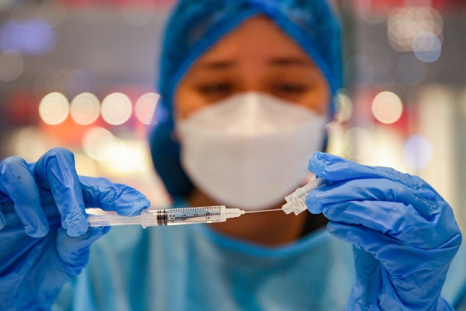 A health worker prepares Pfizer’s COVID-19 vaccines inside a mall in Makati City a day after the Department of Health (DOH) issued guidelines for its nationwide rollout on July 28, 2022. George Calvelo, ABS-CBN News/File