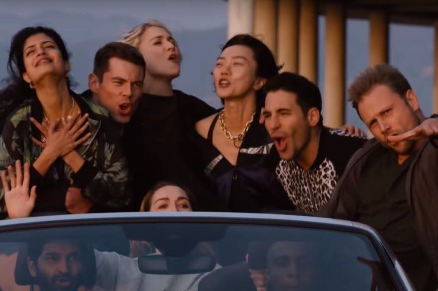 The eight main characters of Sense8 in a convertible joyously singing along to I Feel You by Depeche Mode in the series finale