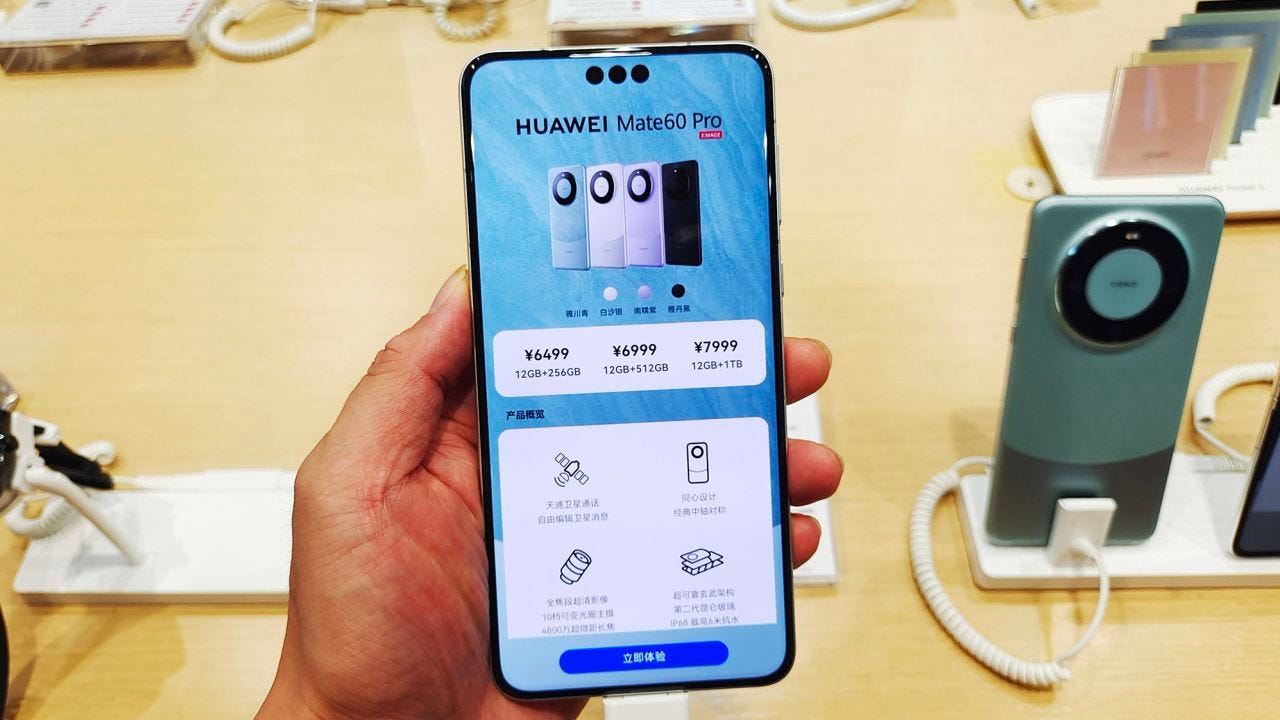 Customers experience the newly released Huawei Mate 60 Pro flagship phone at Huawei's flagship store in Shanghai, China, September 5, 2023. The phone comes with Huawei's latest Hormony 4.0 system, a Kirin 9000s chip, a satellite phone and 5G standard Internet speeds.