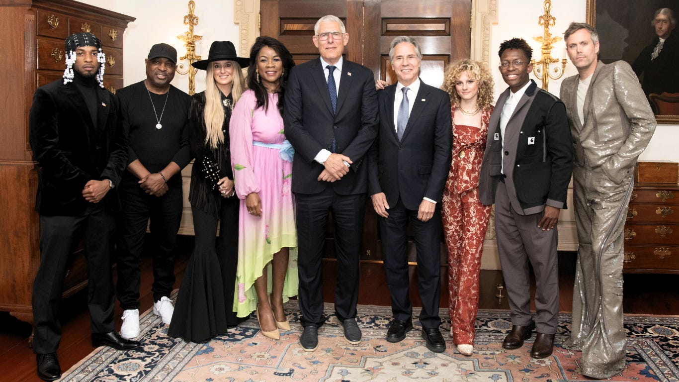 Chuck D Lyor Cohen, center, and Antony Blinken