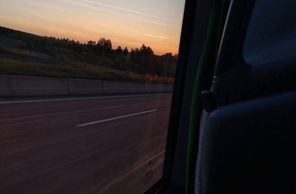 Picture of sunset over field from a bus window
