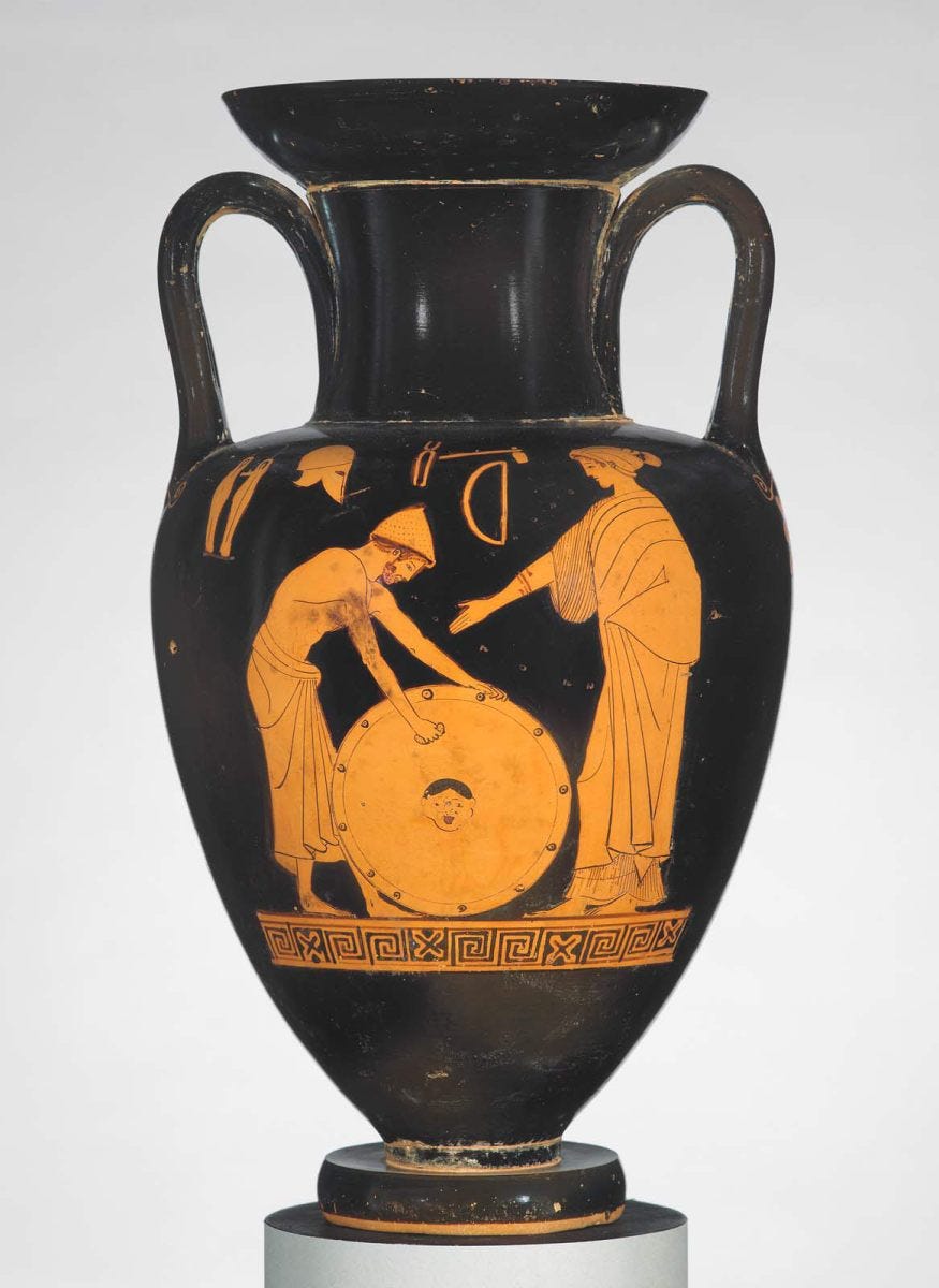 Red figure vase: Hephaistos polishing the shield of Achilles in the presence of Thetis. In the field, a pair of greaves, a helmet, tongs, hammer and saw. Meaningless inscription.