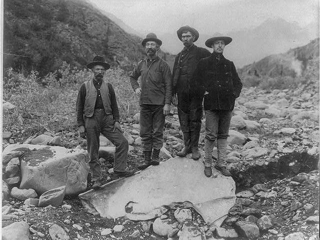 Four Men Standing on Giant Nugget of Copper