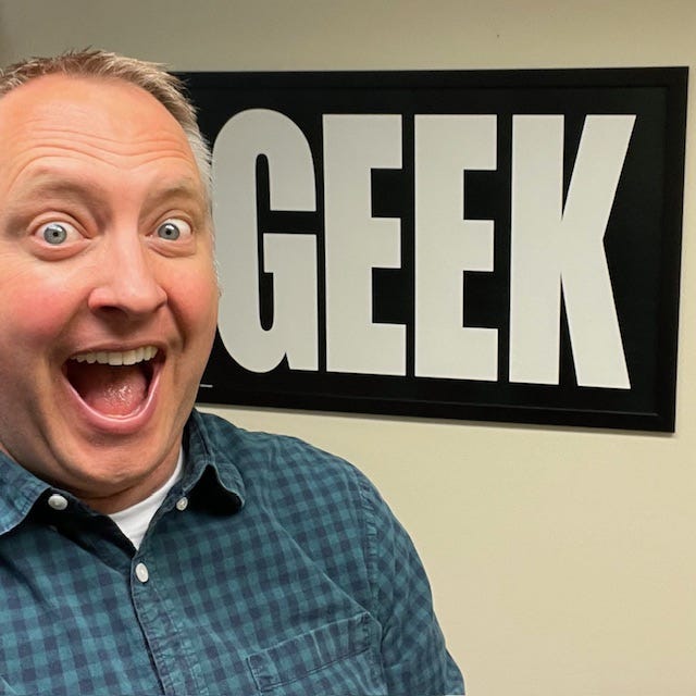 Dr. Dave with the "GEEK" sign in his office