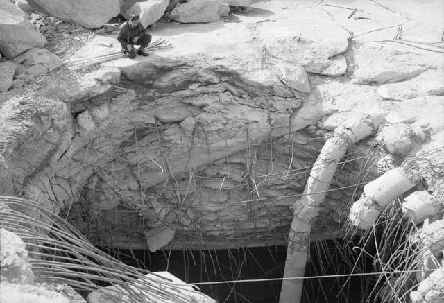 r/HistoryPorn - An RAF officer inspects the hole left by a 'Grand Slam' bomb penetrated German submarine pens at Farge, north of Bremen, Germany. 27 March 1945, [800x547]