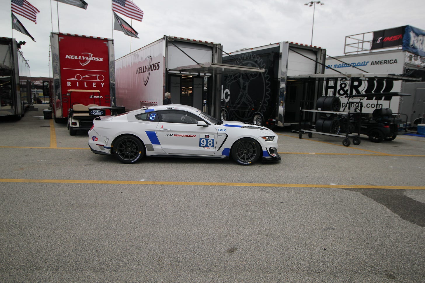 Ford CEO Jim Farley drives the No. 98 Ford Multimatic Motorsports GT4 back through the garage area following his first IMSA race.