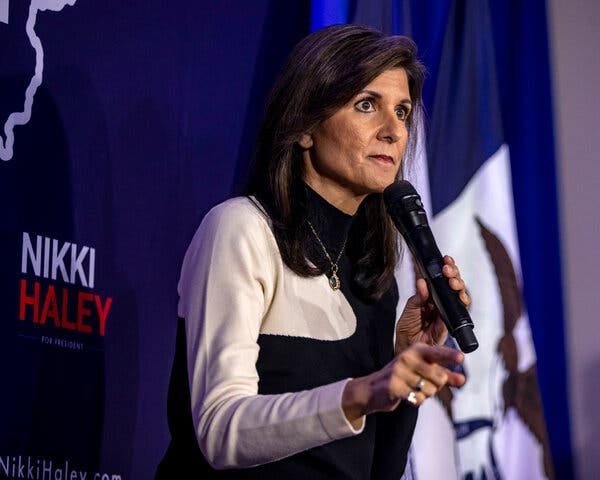 Nikki Haley speaking into a microphone and pointing with her right hand.