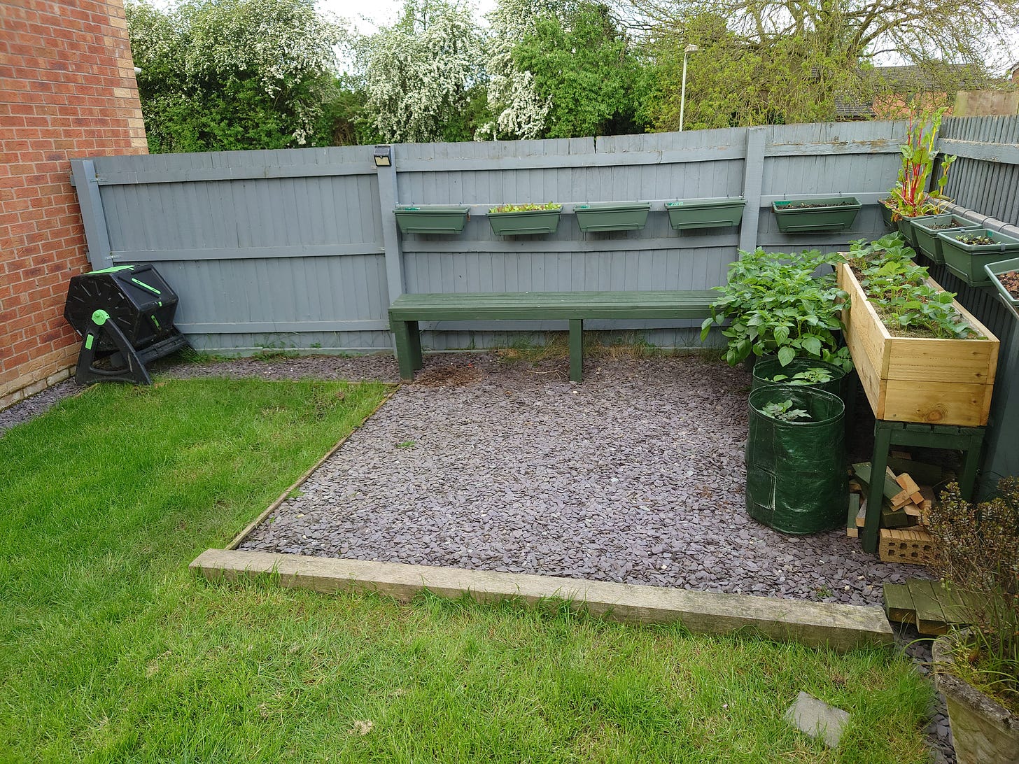 Photo of lower back garden in May when it was only grass and slate chips