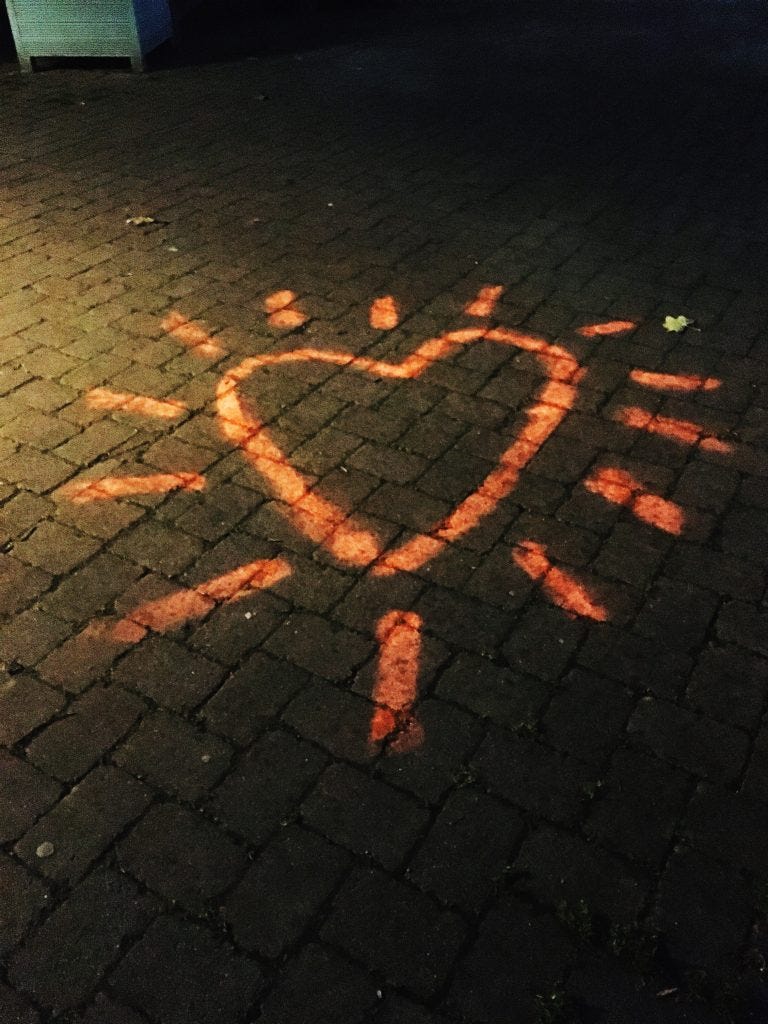Pink chalk heart on a pavement