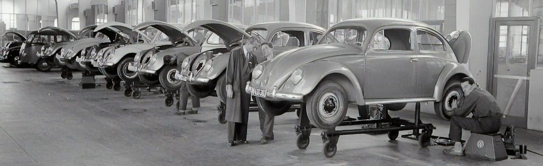 grayscale photo of vintage cars parked in front of building