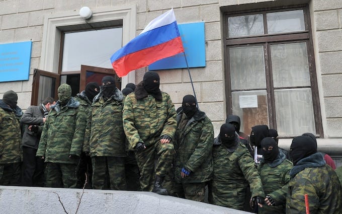 Masked men acting in the name of Russia take over an administrative building in Crimea's capital, Simferopol, in 2014