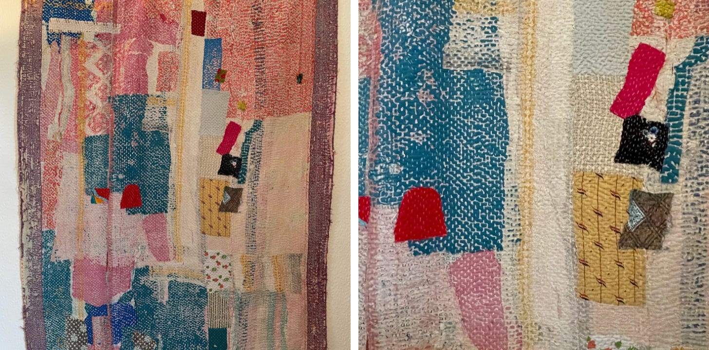 A mostly pink and blue quilt with red and yellow accents.
