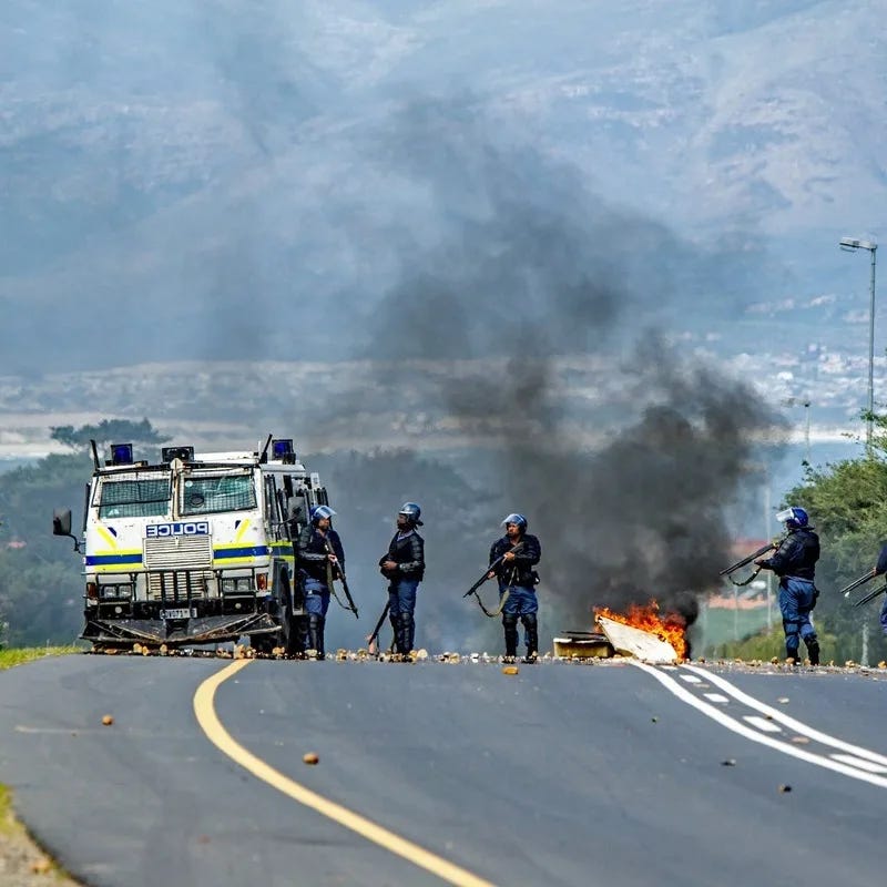 Armed Police Patrolling A Motorway Where A Car Is Seen Burning, Western Cape, South Africa, Sub Saharan Africa