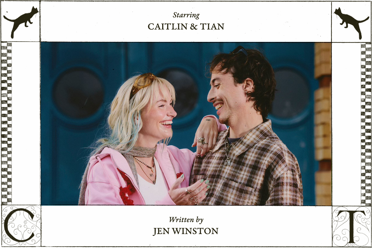 Caitlin and Tian smile at each other, faces close in an affectionate moment. Surrounded by a stylized frame that reads “Starring Caitlin & Tian” and “Written by Jen Winston,” with cat illustrations and ornate initials C and T in the corners.